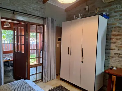 a bedroom with a large white cabinet in a room at 1@Kruger Unit 3 in Mokopane