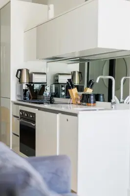 a kitchen with a stove and a sink with pots and pans at Elipse Waterfall-2802 in Midrand