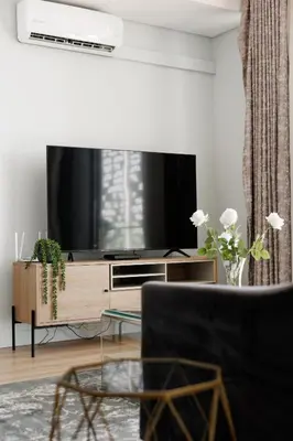 a living room with a flat screen tv on a entertainment center at Elipse Waterfall-2802 in Midrand
