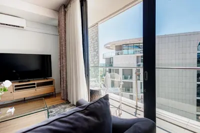 a living room with a tv and a large window at Elipse Waterfall-2802 in Midrand