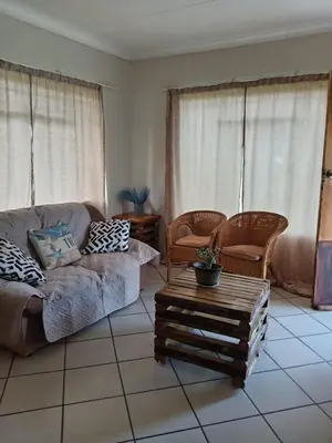 a living room with a couch and chairs and a table at Le Paradise holiday resort in Badplaas