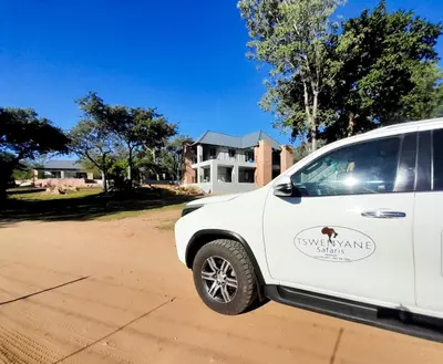 a white van parked in front of a house at Tswenyane Kruger Riverview Apartments in Marloth Park