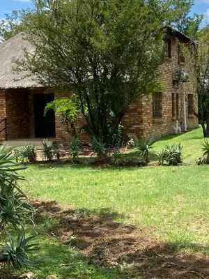a brick house with a tree in the yard at Pop inn 74 in Midrand