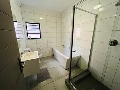 a bathroom with a shower and a tub and a sink at Large 3 Bedroom Apartment in Midrand, Waterfall City - More space than a hotel room - Ideal for families, groups and work trips - 20 Elizabeth Place in Midrand
