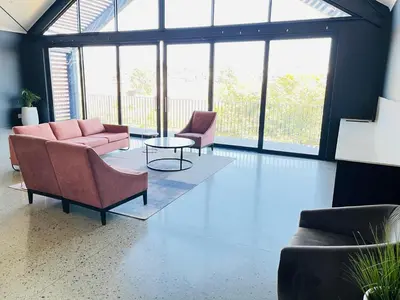 a living room with couches and a table and windows at Large 3 Bedroom Apartment in Midrand, Waterfall City - More space than a hotel room - Ideal for families, groups and work trips - 20 Elizabeth Place in Midrand