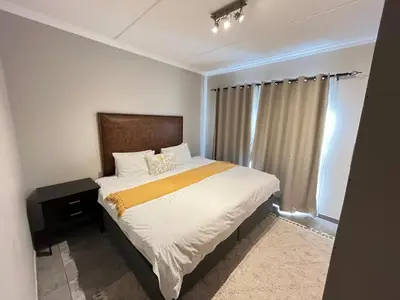 a bedroom with a bed and a window at Large 3 Bedroom Apartment in Midrand, Waterfall City - More space than a hotel room - Ideal for families, groups and work trips - 20 Elizabeth Place in Midrand