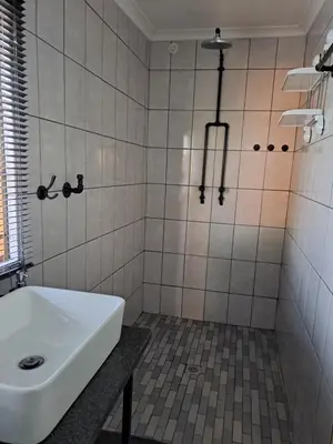a bathroom with a sink and a white tub at Rustic Farm Stay in Lydenburg