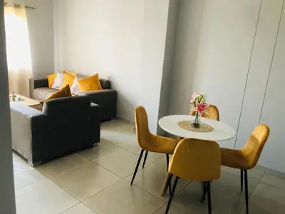 a living room with a table and chairs and a couch at Menlyn Place Vacay in Pretoria