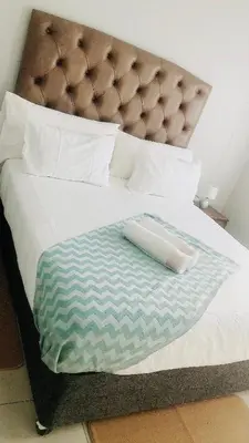 a large bed with a blanket on top of it at Menlyn Place Vacay in Pretoria