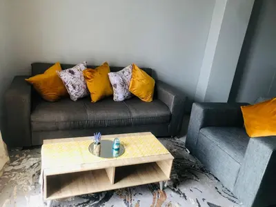 a living room with a couch and a coffee table at Menlyn Place Vacay in Pretoria