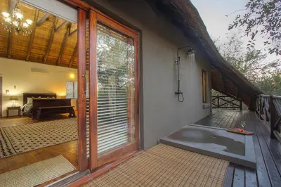 an entrance to a house with a glass door at Luxury GuesthouseCo HoneymoonHouse in Marloth Park