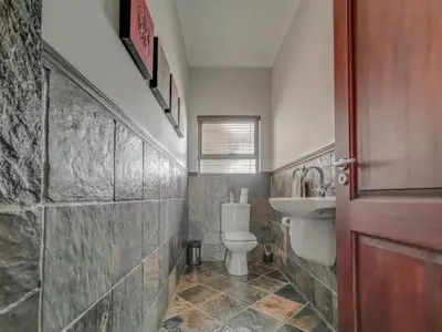 a bathroom with a toilet and a sink at Sunshine Retreat @ Zebula in Mabula