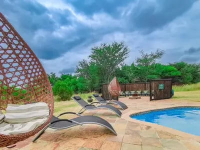 a group of chairs sitting next to a swimming pool at Sunshine Retreat @ Zebula in Mabula