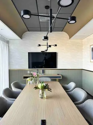 a conference room with a table with chairs and a television at Explore Ellipse - Nguni Room in Midrand