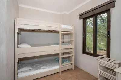two bunk beds in a room with a window at Nokuthula Bush Retreat in Marloth Park