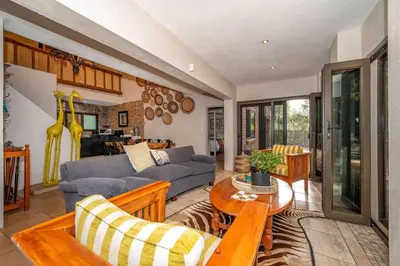 a living room with a couch and a table at Nokuthula Bush Retreat in Marloth Park