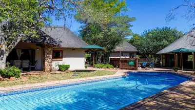 an image of a house with a swimming pool at Hornbill House @ Zebula in Mabula
