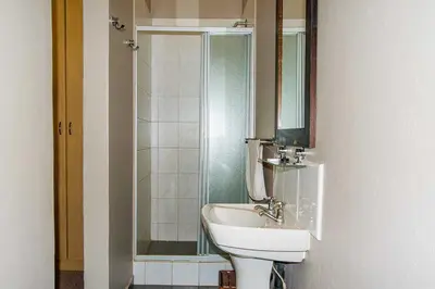 a bathroom with a sink and a shower at RIETONDALE LODGE in Pretoria