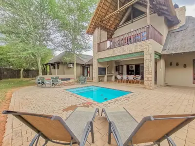 a patio with chairs and a swimming pool at Nyala's Corner @ Zebula in Mabula