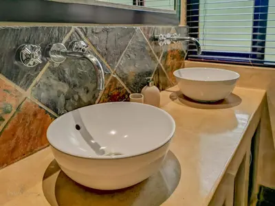 a bathroom with a bowl sink on a counter at Nyala's Corner @ Zebula in Mabula