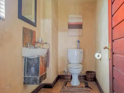 a bathroom with a toilet and a sink at Nyala's Corner @ Zebula in Mabula