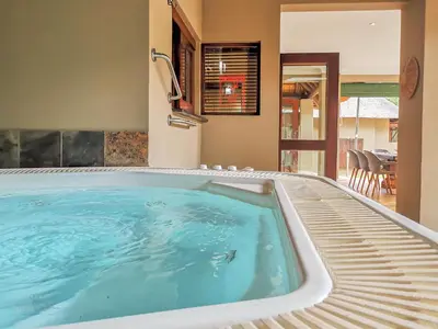 a hot tub in a room with a patio at Nyala's Corner @ Zebula in Mabula