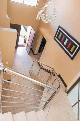 a staircase with a shopping cart in a building at Ray of sunshine in Centurion