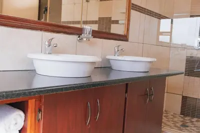 two sinks on a counter in a bathroom at Ray of sunshine in Centurion