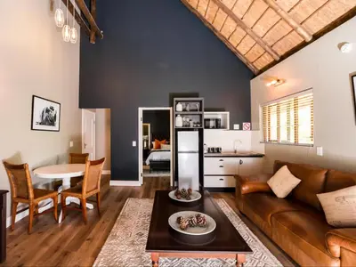 a living room with a couch and a table at Celtis Manor Guesthouse in Midrand