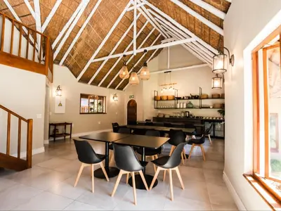a dining room with a table and chairs at Celtis Manor Guesthouse in Midrand