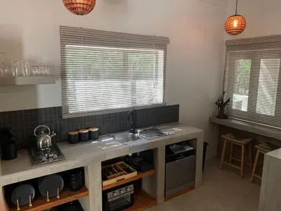 a kitchen with a sink and a counter top at Pango Kruger Home For 2 in Marloth Park