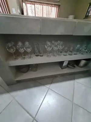 a row of wine glasses sitting on a shelf at marlothpride in Marloth Park