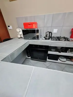 a kitchen with a counter top with a microwave at marlothpride in Marloth Park