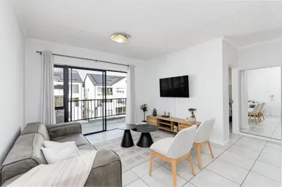 a living room with a couch and a table at Luxury apartment in Kyalami in Midrand