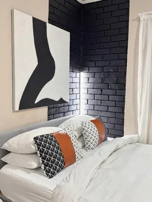 a bedroom with a bed with pillows on it at Pride studio @ The Monarch in Polokwane