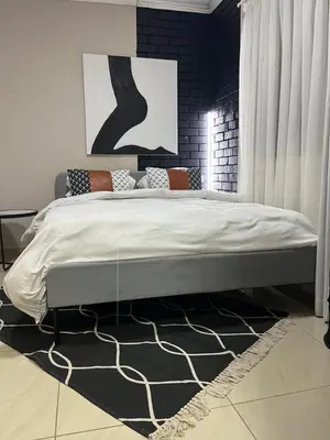 a bedroom with a large bed in a room at Pride studio @ The Monarch in Polokwane