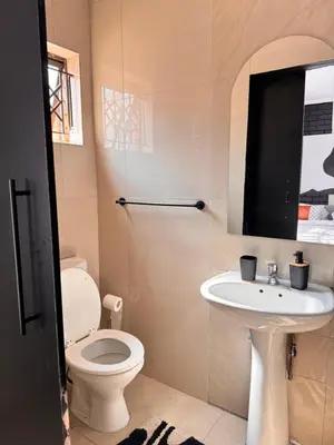 a bathroom with a toilet and a sink at Pride studio @ The Monarch in Polokwane