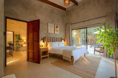 a bedroom with a bed and a large window at The Duchess Luxury Safari Villa, Close to KNP, Giraffe-Feeding-Tower, Bush-Bath, Boma in Marloth Park