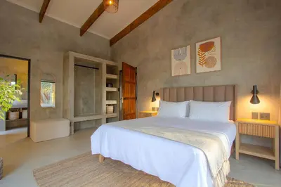 a bedroom with a large white bed in a room at The Duchess Luxury Safari Villa, Close to KNP, Giraffe-Feeding-Tower, Bush-Bath, Boma in Marloth Park