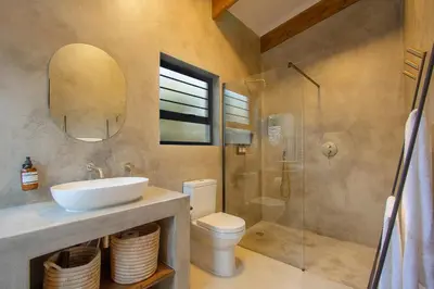 a bathroom with a sink and a toilet and a shower at The Duchess Luxury Safari Villa, Close to KNP, Giraffe-Feeding-Tower, Bush-Bath, Boma in Marloth Park