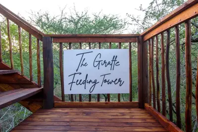a sign on a wooden deck with a sign on it at The Duchess Luxury Safari Villa, Close to KNP, Giraffe-Feeding-Tower, Bush-Bath, Boma in Marloth Park