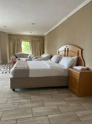 a bedroom with a large bed in a room at Goldpot Garsfontein 6 minutes away from SunBet Arena at Time Square Casino in Pretoria