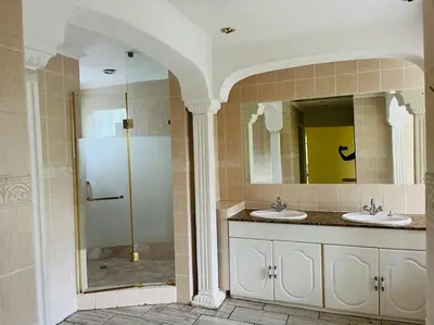 a bathroom with two sinks and a shower at Goldpot Garsfontein 6 minutes away from SunBet Arena at Time Square Casino in Pretoria