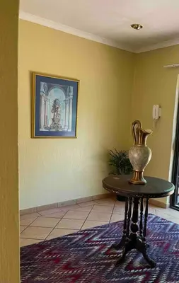 a vase sitting on a table in a room at Goldpot Garsfontein 6 minutes away from SunBet Arena at Time Square Casino in Pretoria