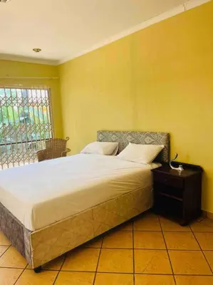 a bedroom with a large bed with a window at Goldpot Garsfontein 6 minutes away from SunBet Arena at Time Square Casino in Pretoria