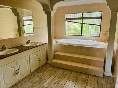 a large bathroom with two sinks and a tub at Goldpot Garsfontein 6 minutes away from SunBet Arena at Time Square Casino in Pretoria