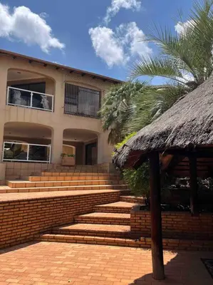 a building with stairs and a straw roof at Goldpot Garsfontein 6 minutes away from SunBet Arena at Time Square Casino in Pretoria