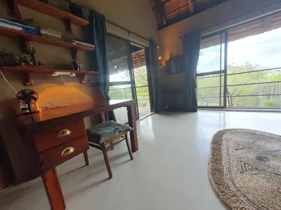 a room with a desk with a chair and a window at WIFI Luxury holiday villa Zebra's Nest at Kruger in Marloth Park