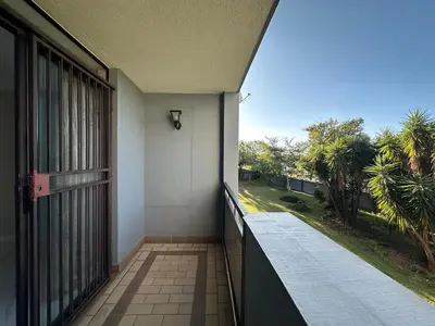 a balcony with a door and a view of a yard at Lux Living at Menlyn Place in Pretoria