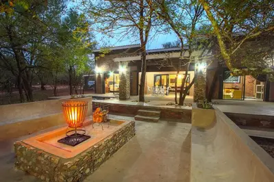 a building with a lamp in front of it at Leopard Crest in Marloth Park